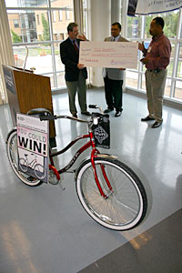 Left to right, Mike Drake, Algie Gatewood and James Bowles show off the check.