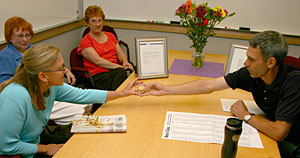 Kimberley Miller is handed her award by instructor Greg Rapp.