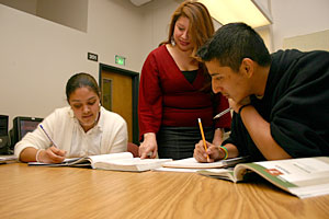 Teresa Alonso (center), CAMP director, helps CAMP students Flor Medina (left) and Jesus Andrade during a tutoring session at the Rock Creek Campus.