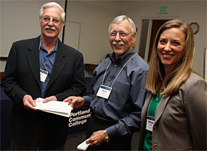 PCC Foundation Board President Peter Bauer, center, receives a $25,000 check from Curt Fluhrer and Melissa Durham of the Oregon Community Foundation