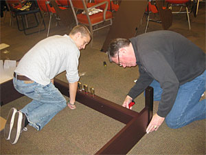 Michael and Tim Stephenson of Stephenson & Associates, a Hillsboro distributor for Rodgers/Roland Products, build a Roland RP101 digital electronic piano in the PCC Rock Creek music room.