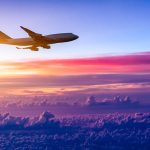 airplane in the sky at sunrise