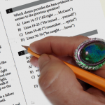 a test taker is wearing a gauche ring with a stone jewel while taking a paper exam