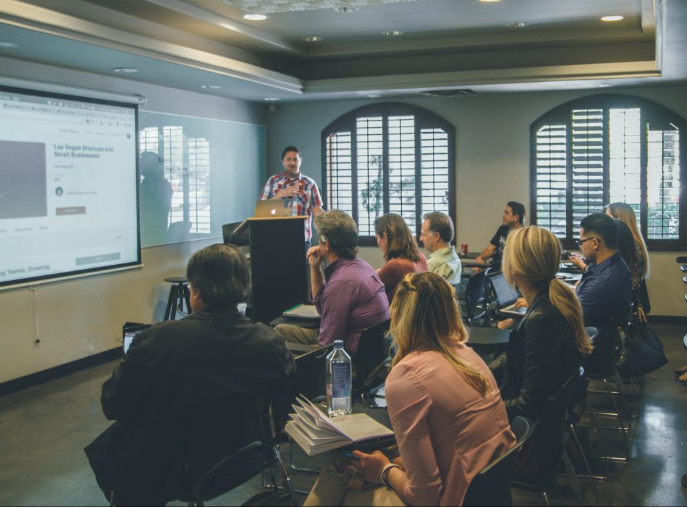 Teacher in front of a group of adult students