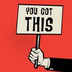 A hand holding a sign that says "You got this"