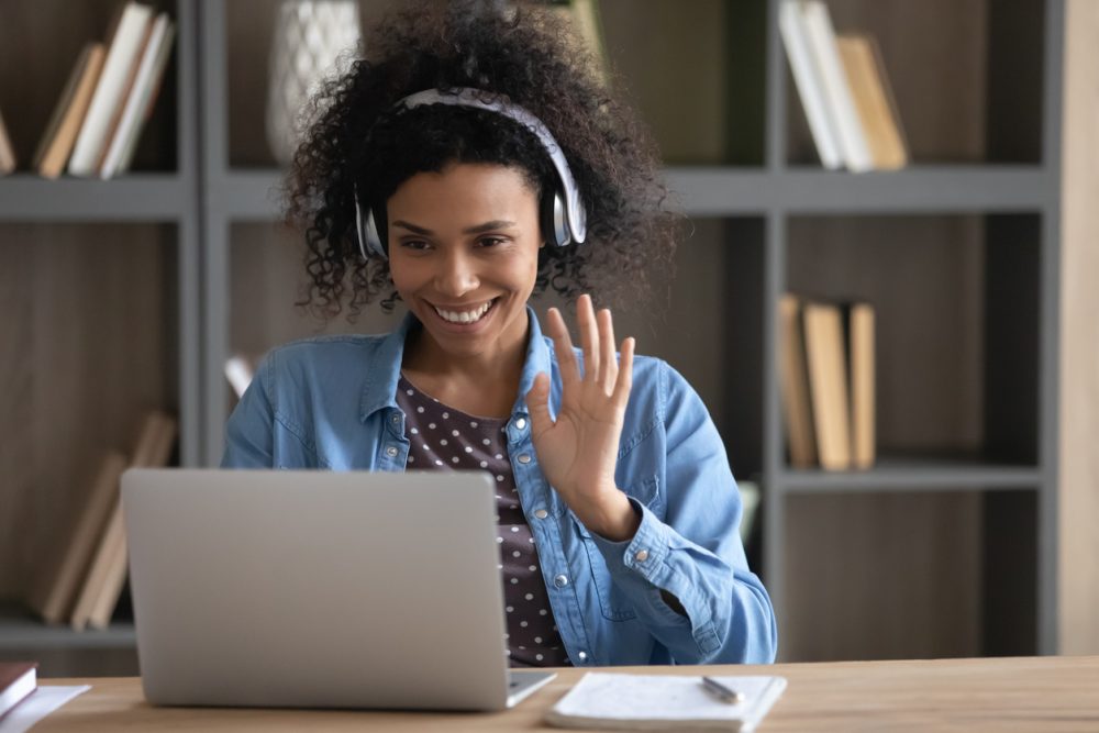 Student waving hello on a video call