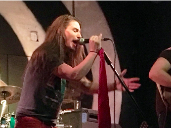 Metal vocalist Gene Summers sings into a microhone. 