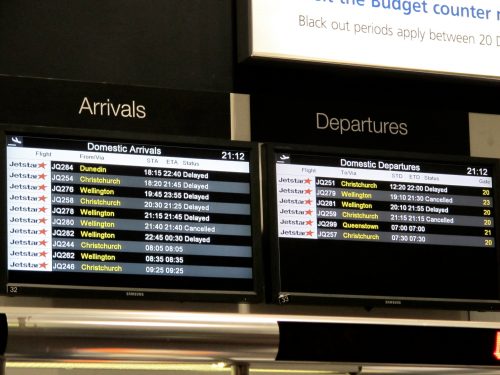 Airport flight board showing lots of delayed and canceled flights