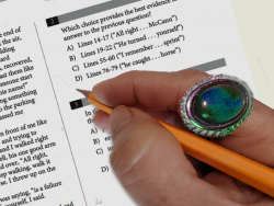 a test taker is wearing a gauche ring with a stone jewel while taking a paper exam
