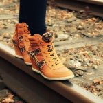 Feet balancing on a railroad track