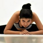 woman in a splits pose showing flexibility
