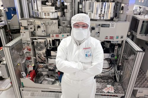 Woman in a semiconductor lab wearing a protective uniform. Photo credit: Intel