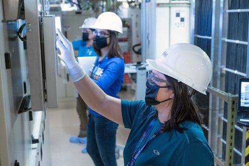 Women in a semiconductor lab wearing hard hats. Photo credit: Intel