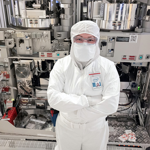 Woman in a semiconductor lab wearing a protective uniform. Photo credit: Intel