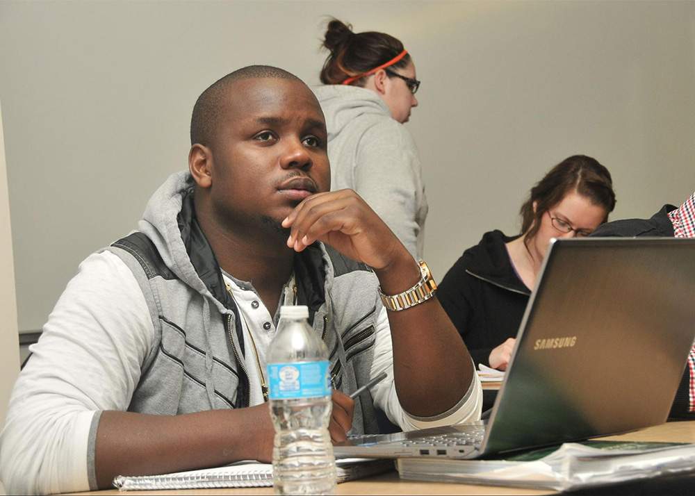 Student in a classroom with a laptop