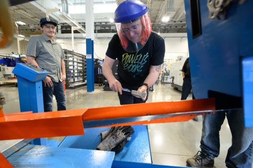 Student measuring at bandsaw