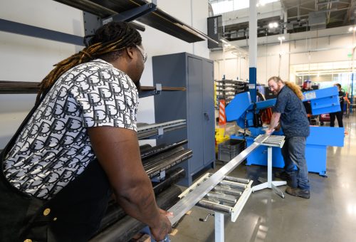 Instructor & student with metal bar
