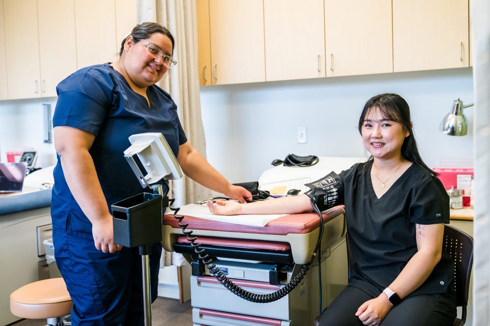 Students taking blood pressure in class