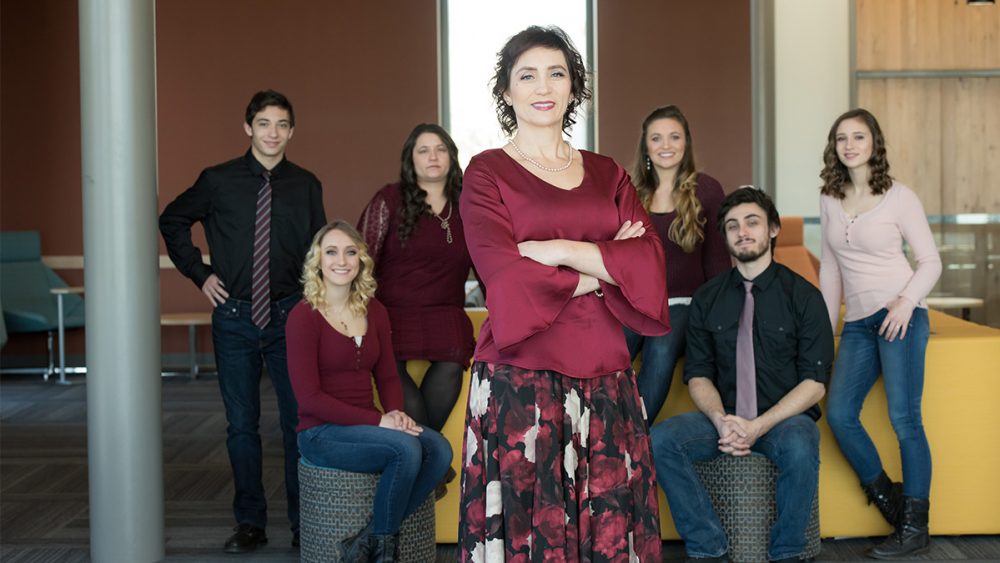 Tera Roberts standing in front of six of her children