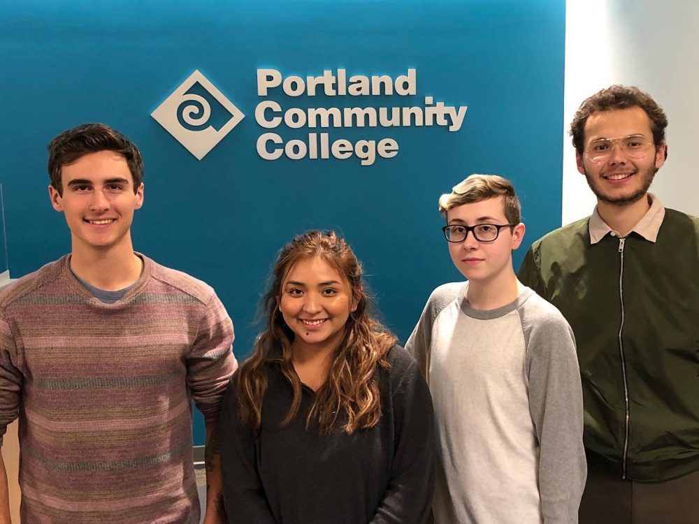 2019-20 interns in front of a turquoise wall showing the PCC logo