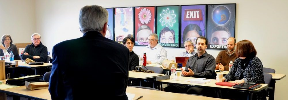 SBDC classroom with five professionals discussing global trade.