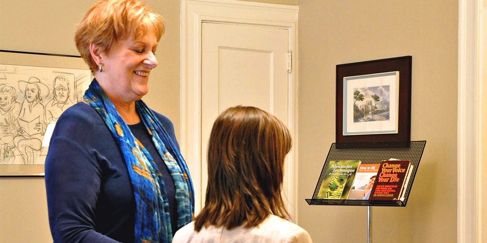 Woman teaches breathing exercises to student at business Breath is the Answer