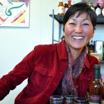 River Wave Foods owner Rebecca Kawanami smiling with her tapenade product line