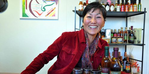 River Wave Foods owner Rebecca Kawanami smiling with her tapenade product line