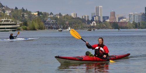 Kayaker in front of the Portland downtown skyline