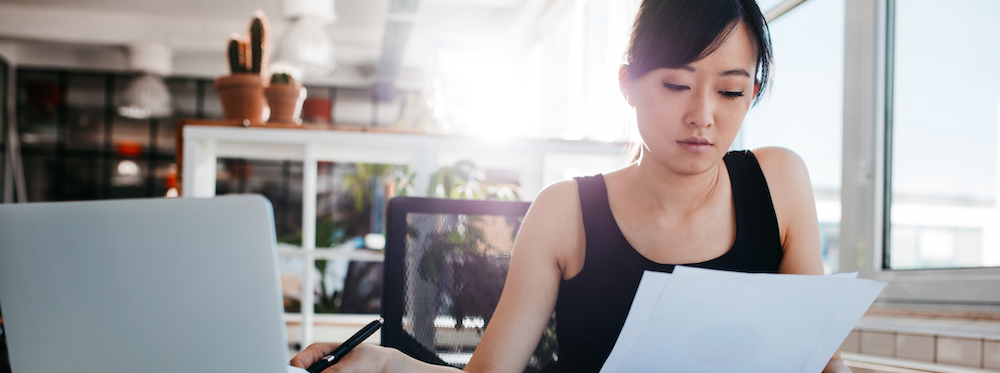 Businesswoman doing paperwork at her workplace