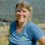 Jennifer Peters smiling in a blue shirt standing outside