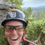 Teacher smiling in outdoor headshot 