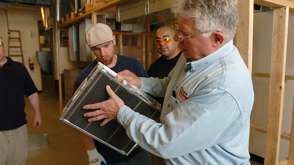 Students looking at materials in the classroom with an instructor