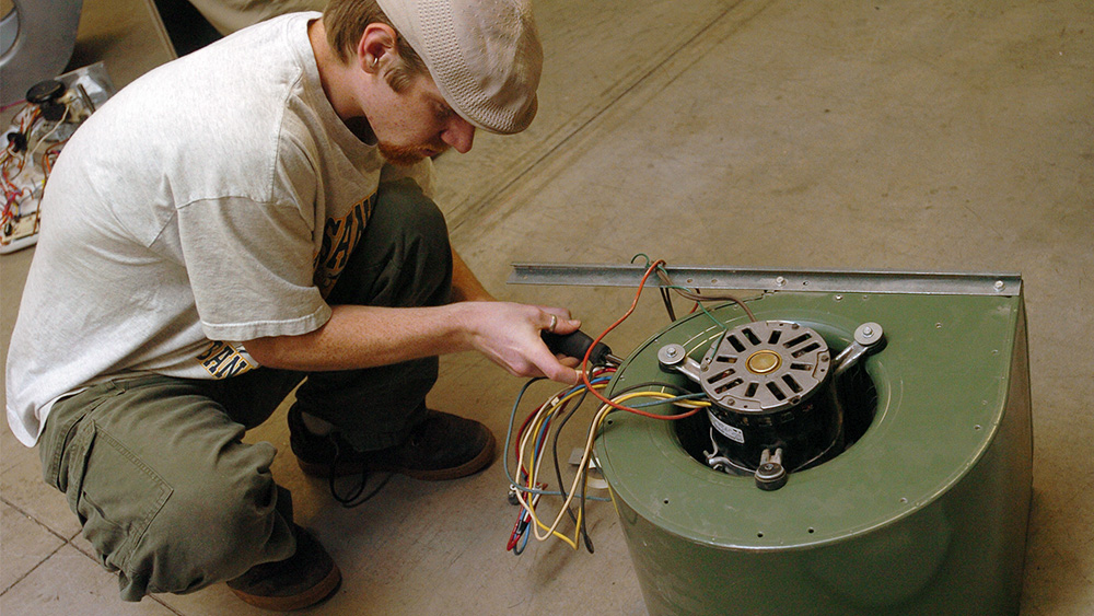 Student working with a piece of machinery