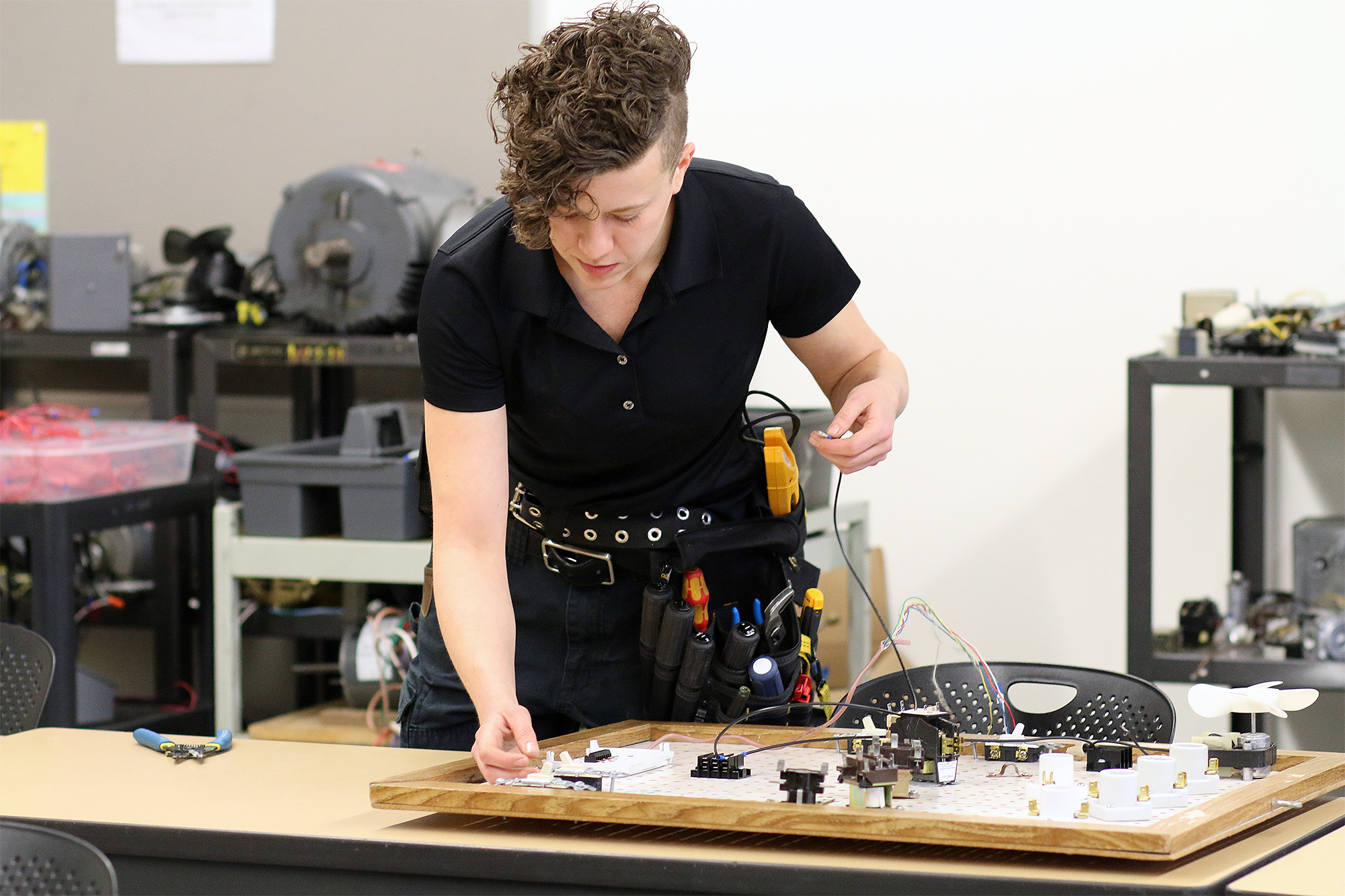 Apprenticeship student working on an electrical board