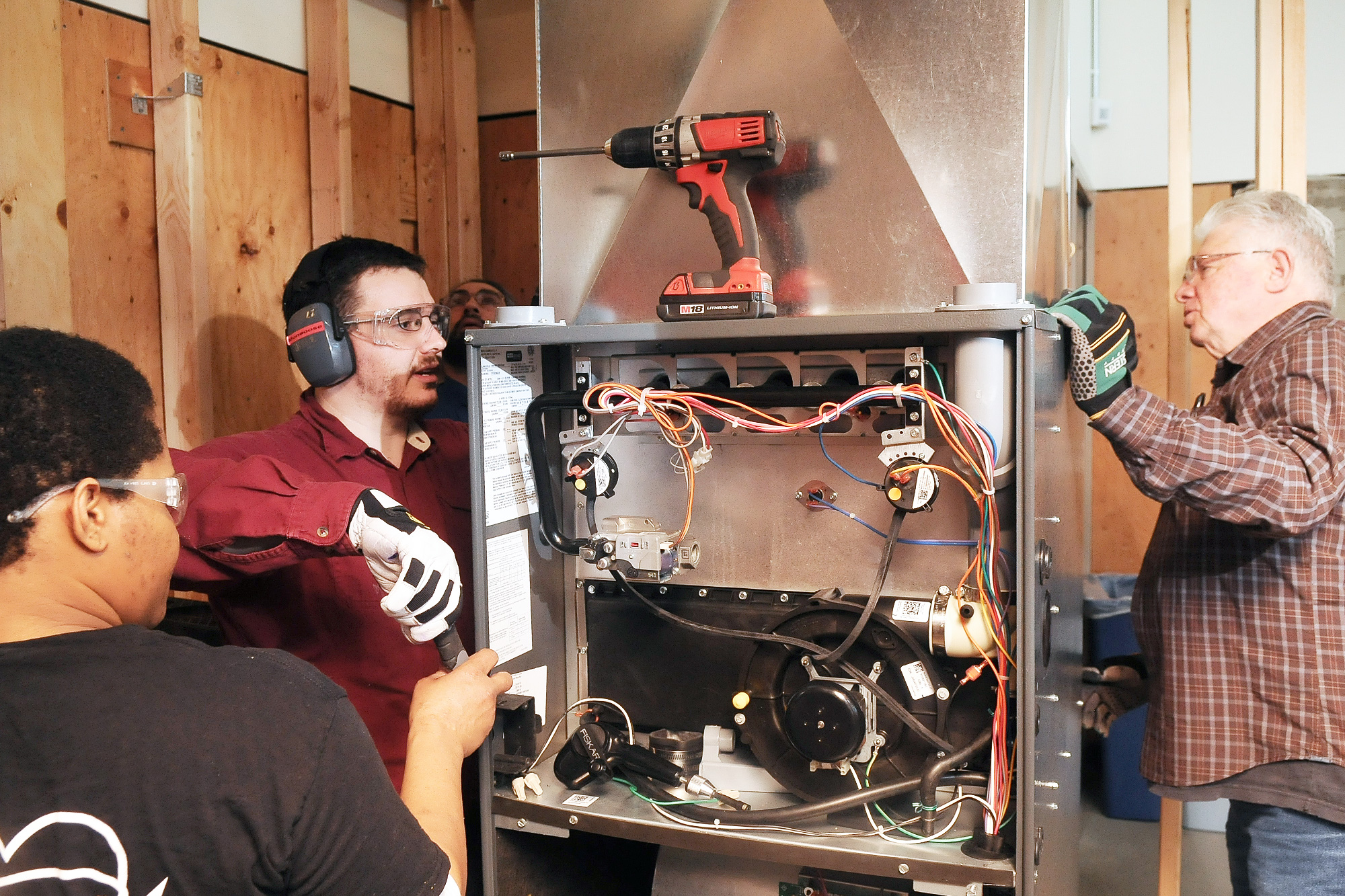 Apprenticeship students working with the electronics on an HVAC/R unit