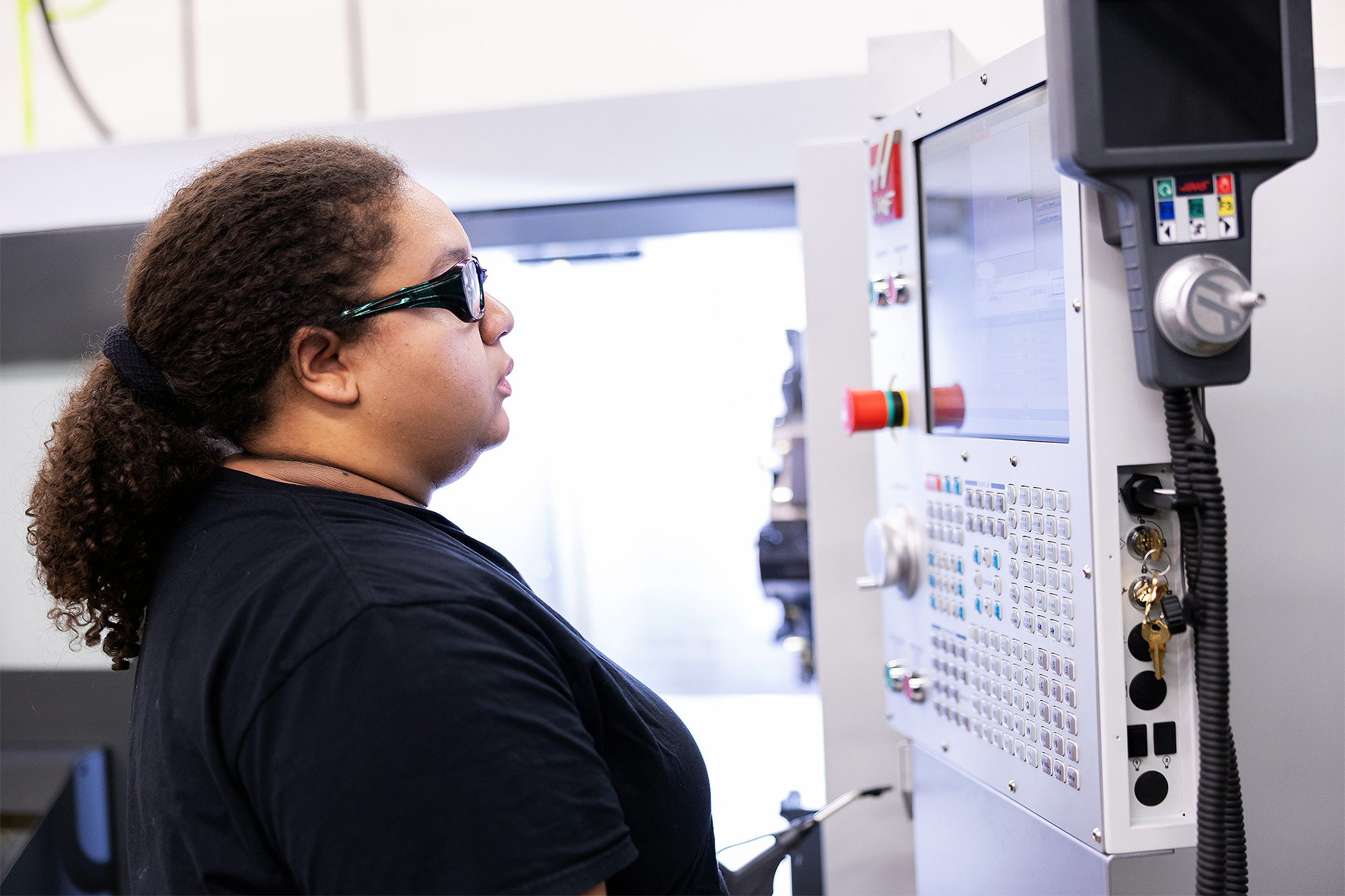 Apprenticeship student using machining equipment