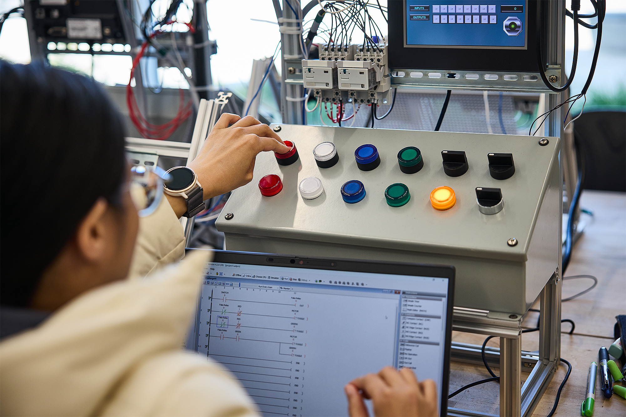 Apprenticeship student using programmable logic equipment