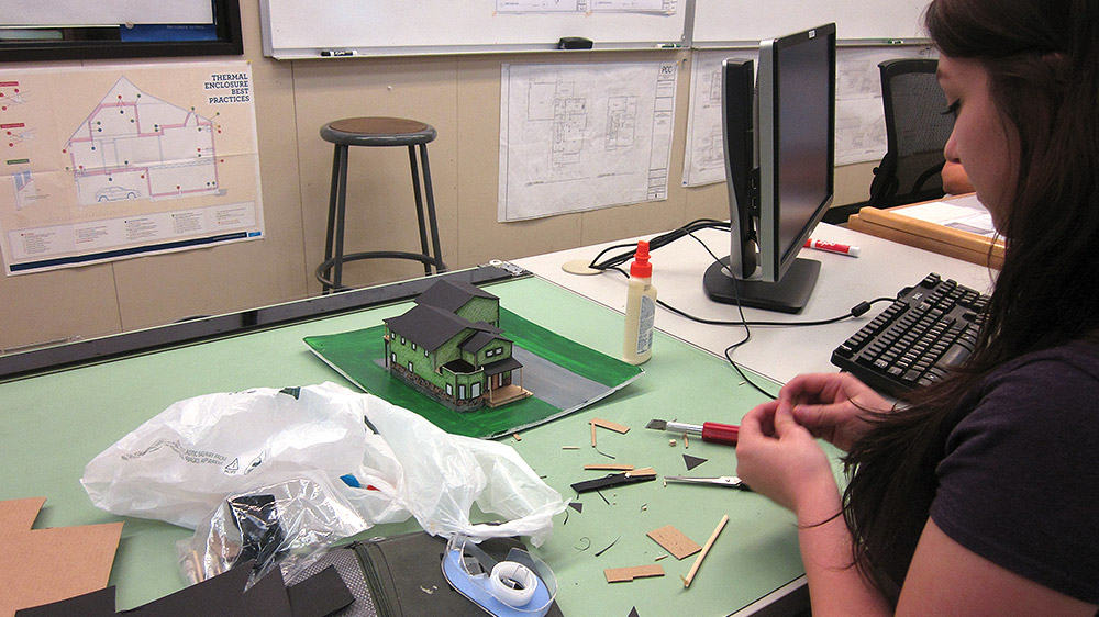 Student making a model of a house in class
