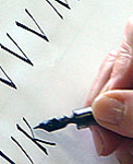 Student writing calligraphic letters