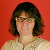 Rachel Siegel in front of a red wall