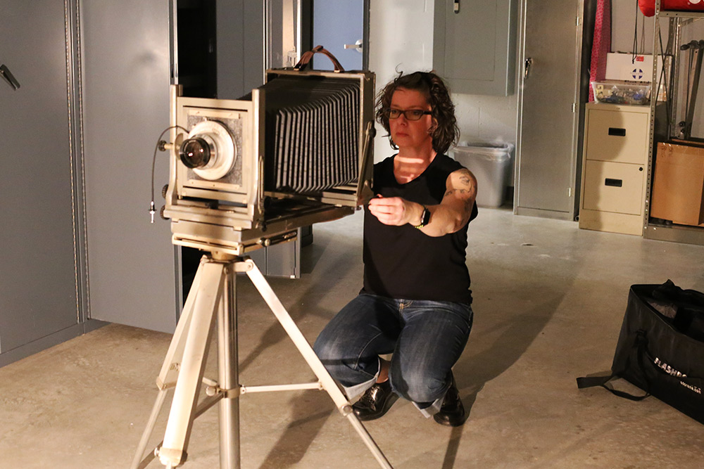 Instructor using a vintage plate camera in the studio