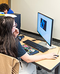Student making art on a computer