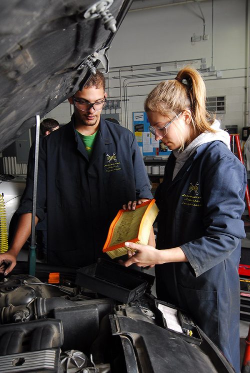 Students changing an air filter