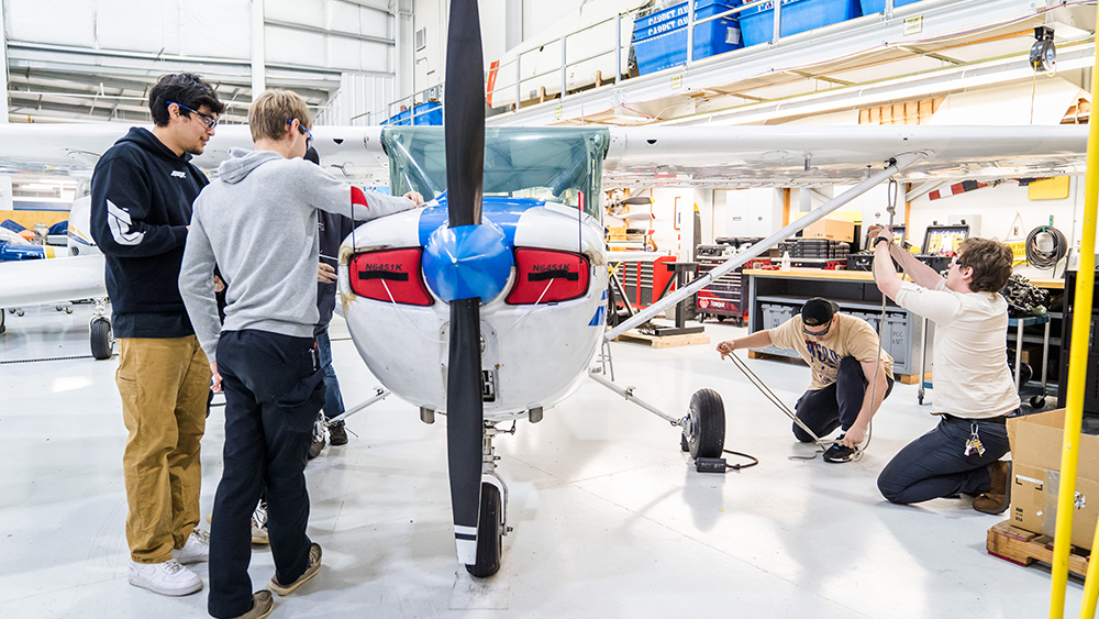Students working on a plane