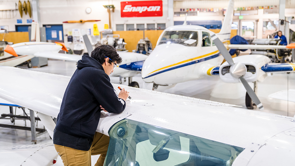 A student working on an airplane