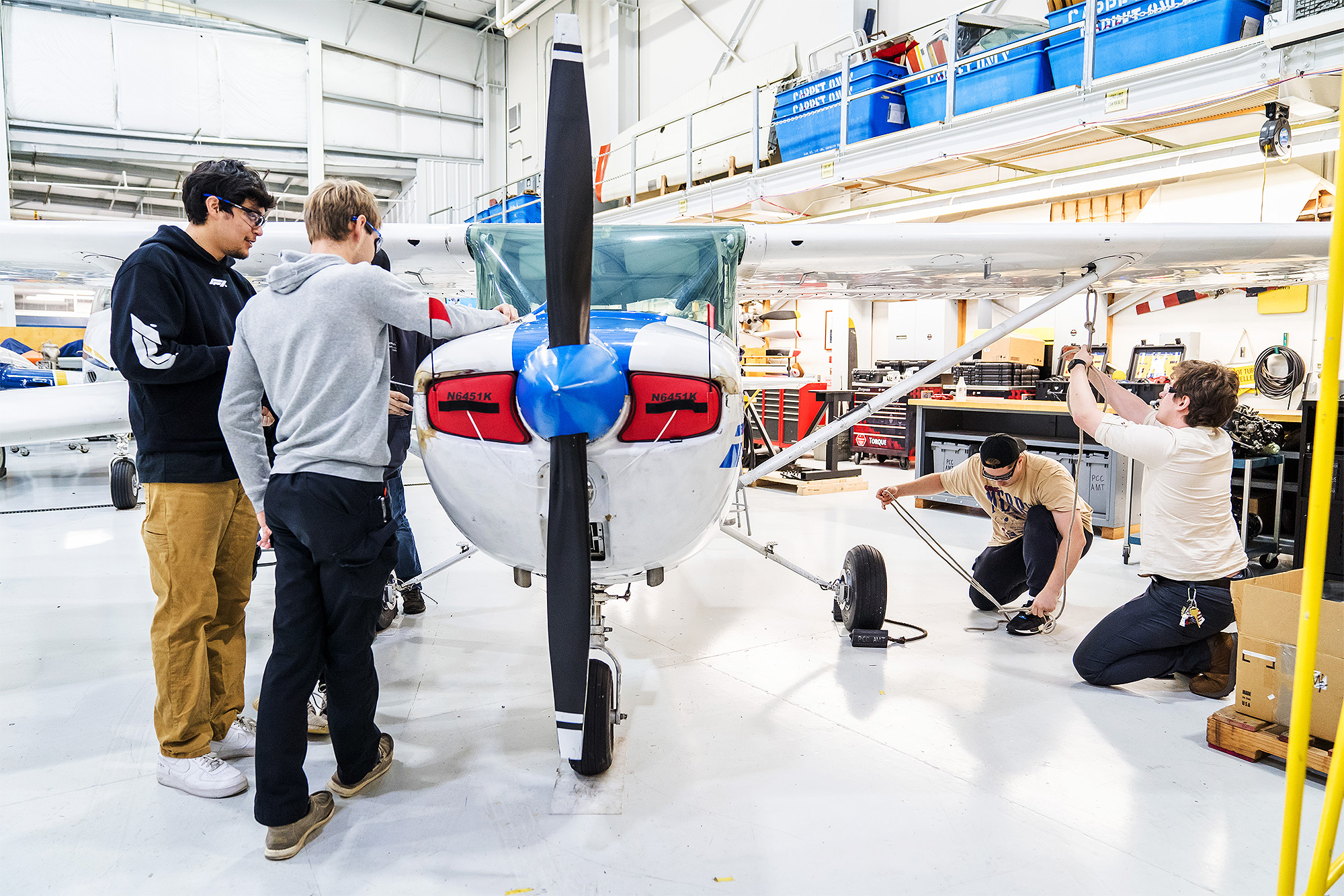 Aviation Maintenance students working on an airplane together