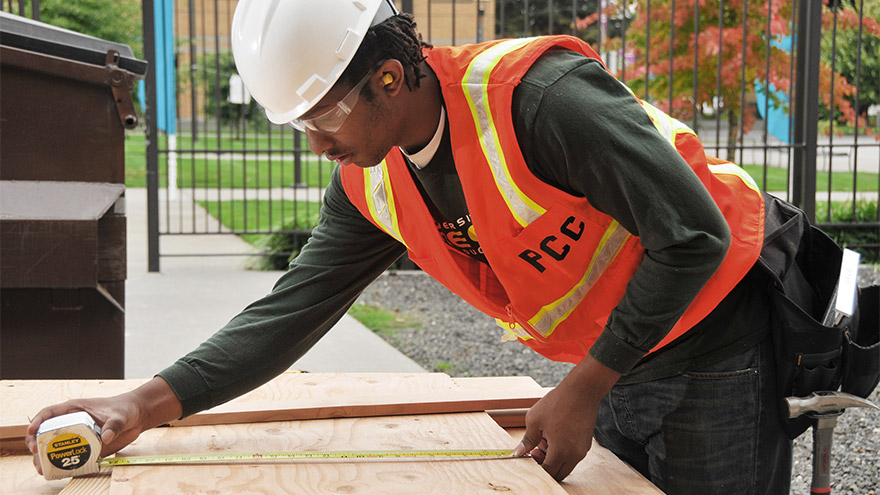 Student using a tape measure