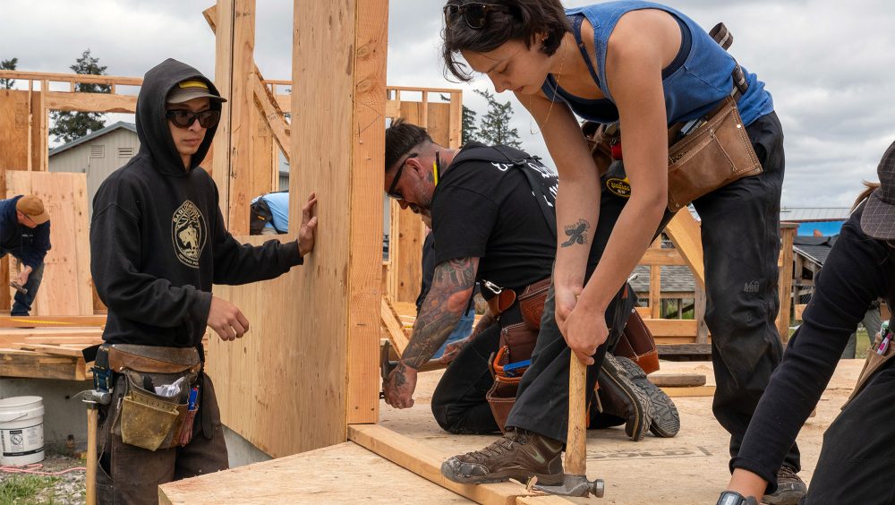 Students framing a wall together