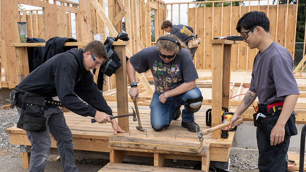 Students hammering and framing a wall